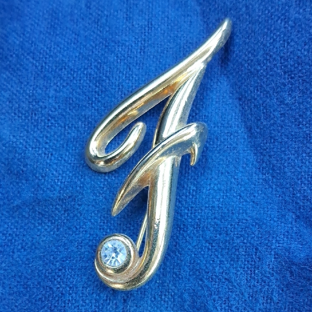 Monet Gold-Tone Script 'F' Brooch with Clear Stone